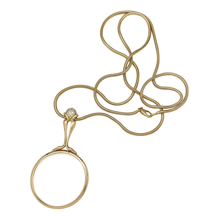 Yellow gold chain and magnifying glass, diamonds.