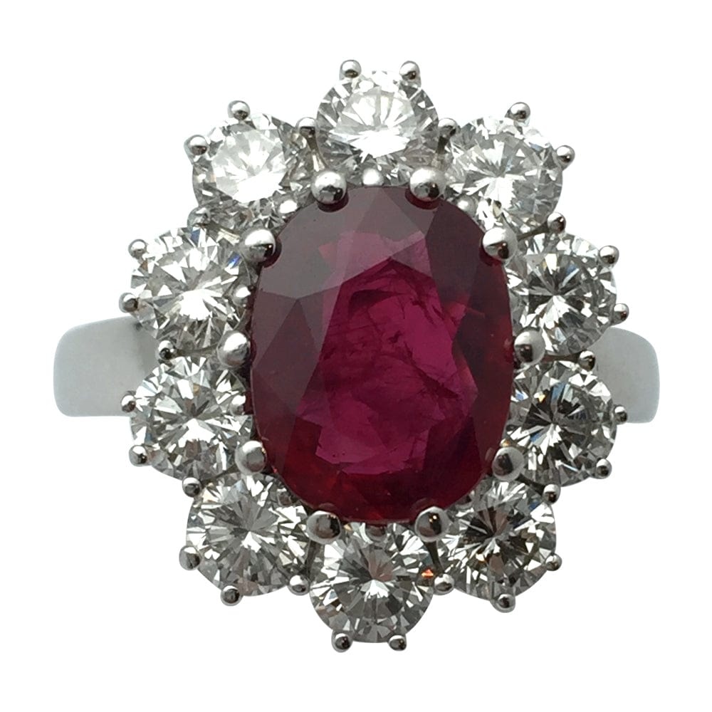 White gold ring, oval ruby surrounded by diamonds.